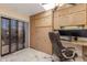 A home office featuring a built-in desk, cabinets, neutral finishes and a door to a balcony or patio at 8675 S College Ln, Tempe, AZ 85284
