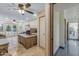 A spacious home office with two ceiling fans, a large desk and many windows at 8675 S College Ln, Tempe, AZ 85284
