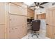 An office area with a Murphy bed, desk, cabinets, and a laundry room nearby at 8675 S College Ln, Tempe, AZ 85284