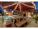 The patio features comfortable dining next to a refreshing pool, and outdoor kitchen, ideal for summer relaxation at 8675 S College Ln, Tempe, AZ 85284