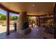 Inviting covered patio area features a cozy fireplace and views of the sparkling pool at 8675 S College Ln, Tempe, AZ 85284