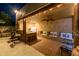 Covered outdoor kitchen with a bar, built-in seating, and modern appliances perfect for entertaining near the pool at 8675 S College Ln, Tempe, AZ 85284