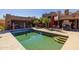 Pool and patio featuring steps into the pool, outdoor seating area, desert landscaping, and umbrellas at 8675 S College Ln, Tempe, AZ 85284