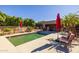 Beautiful pool area with lounge chairs, mature landscaping, shade umbrellas, and dining area at 8675 S College Ln, Tempe, AZ 85284