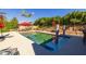 Pool area features a shade umbrella, desert landscaping, and mature trees surrounding the patio at 8675 S College Ln, Tempe, AZ 85284