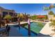 Sparkling pool with surrounding patio, poolside dining and shade structures, and lush landscaping at 8675 S College Ln, Tempe, AZ 85284
