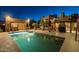 Inviting pool area at night with a swim-up bar and seating, complemented by the covered grill and dining spaces at 8675 S College Ln, Tempe, AZ 85284
