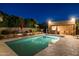 Outdoor oasis featuring a beautiful pool, outdoor kitchen, and lush landscaping for tranquil relaxation and summer enjoyment at 8675 S College Ln, Tempe, AZ 85284