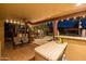 Outdoor bar with granite countertop overlooks patio, pool, and lounge area, perfect for entertaining at 8675 S College Ln, Tempe, AZ 85284