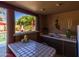 Covered poolside bar features tiled counter, sink, and a view of the pool area and landscaping at 8675 S College Ln, Tempe, AZ 85284
