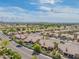 Aerial view of homes with pools, golf course, and mountain views within the community at 8839 W Rimrock Dr, Peoria, AZ 85382