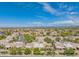Aerial view of homes with lush trees and golf course views within the community at 8839 W Rimrock Dr, Peoria, AZ 85382