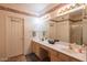 Well-lit bathroom with dual sinks, vanity, and shower, providing ample space and functionality at 8839 W Rimrock Dr, Peoria, AZ 85382
