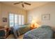 Cozy bedroom featuring twin beds, window shutters and neutral color palette, creating a relaxing and inviting space at 8839 W Rimrock Dr, Peoria, AZ 85382