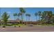 Community building with beautiful landscaping, palm trees, and ample parking for residents at 8839 W Rimrock Dr, Peoria, AZ 85382