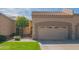 Charming home featuring a two-car garage, desert landscaping, and a well-manicured lawn under a partly cloudy sky at 8839 W Rimrock Dr, Peoria, AZ 85382