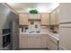 Functional kitchen featuring white cabinets, tile countertops, and stainless steel appliances including a refrigerator at 8839 W Rimrock Dr, Peoria, AZ 85382