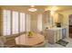 Cozy breakfast nook area with shuttered windows adjacent to kitchen cabinets and a sink at 8839 W Rimrock Dr, Peoria, AZ 85382