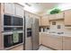 Bright kitchen featuring white cabinets, stainless steel appliances, including a built-in oven and microwave at 8839 W Rimrock Dr, Peoria, AZ 85382