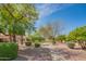 Manicured landscaping with lush trees and shrubbery outside the residential houses at 8839 W Rimrock Dr, Peoria, AZ 85382