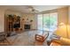 Comfortable living space with fireplace, TV, and patio access, perfect for relaxing or entertaining guests at 8839 W Rimrock Dr, Peoria, AZ 85382