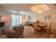 Comfortable living room with a fireplace, plush seating, and access to the patio through sliding glass doors at 8839 W Rimrock Dr, Peoria, AZ 85382