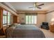 Bright main bedroom with built-in cabinets, large window, and a ceiling fan for a cozy ambiance at 8839 W Rimrock Dr, Peoria, AZ 85382
