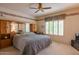 Spacious main bedroom with built-in storage, large window, and a ceiling fan for added comfort at 8839 W Rimrock Dr, Peoria, AZ 85382