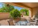 Charming covered patio with ample seating, landscaping, and desert rock, creating a perfect outdoor retreat at 8839 W Rimrock Dr, Peoria, AZ 85382