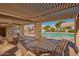 Inviting community pool area featuring shaded seating, BBQ, lounge chairs, and a serene atmosphere at 8839 W Rimrock Dr, Peoria, AZ 85382
