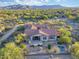 Expansive aerial view of a desert home with a pool, landscaping, and mountain views at 9715 E Allison Way, Scottsdale, AZ 85262
