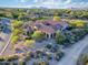 Aerial view of a stunning desert home with a porte cochere and lush landscaping at 9715 E Allison Way, Scottsdale, AZ 85262