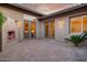 Outdoor patio features a fireplace, double doors, accent lighting, and desert landscaping at 9715 E Allison Way, Scottsdale, AZ 85262