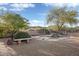 Backyard waterfall feature surrounded by lush landscaping and brick patio at 9715 E Allison Way, Scottsdale, AZ 85262