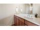 Bathroom with wood cabinets, stone countertop, decorative sink, and modern fixtures at 9715 E Allison Way, Scottsdale, AZ 85262