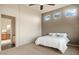 Comfortable bedroom with a ceiling fan, light-colored carpet, and accent wall near the en suite bathroom at 9715 E Allison Way, Scottsdale, AZ 85262