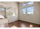 Bright room with hardwood floors and many windows looking out at the desert landscaping at 9715 E Allison Way, Scottsdale, AZ 85262