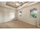 Bright carpeted bedroom with tray ceilings and bright sunny windows at 9715 E Allison Way, Scottsdale, AZ 85262