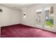 Bright, spacious bedroom features red carpet and access to the private outdoor patio at 9715 E Allison Way, Scottsdale, AZ 85262