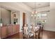 Spacious dining room with hardwood floors, chandelier, and kitchen access at 9715 E Allison Way, Scottsdale, AZ 85262
