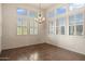 Bright dining room featuring a stylish chandelier and large windows with plantation shutters at 9715 E Allison Way, Scottsdale, AZ 85262