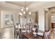 Elegant dining room with modern chandelier and direct access to the outdoors at 9715 E Allison Way, Scottsdale, AZ 85262