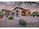 Charming home exterior with lush desert landscaping and a three car garage at 9715 E Allison Way, Scottsdale, AZ 85262