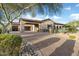 Luxurious home featuring a porte cochere, a brick driveway, and a desert landscape at 9715 E Allison Way, Scottsdale, AZ 85262