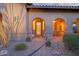 Inviting front porch with elegant glass front door and landscaped yard at 9715 E Allison Way, Scottsdale, AZ 85262