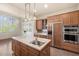 Spacious kitchen features a central island, stainless steel appliances, and custom cabinetry at 9715 E Allison Way, Scottsdale, AZ 85262
