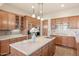 Well-lit kitchen with stone countertops, stainless appliances, and custom cabinetry at 9715 E Allison Way, Scottsdale, AZ 85262