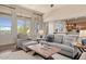 Bright living room featuring a ceiling fan, fireplace, and access to the outdoors at 9715 E Allison Way, Scottsdale, AZ 85262