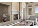 Comfortable living room with a stone fireplace, neutral colors, and natural light at 9715 E Allison Way, Scottsdale, AZ 85262