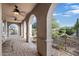 Inviting outdoor patio area with arched columns, ceiling fans, and comfortable seating at 9715 E Allison Way, Scottsdale, AZ 85262